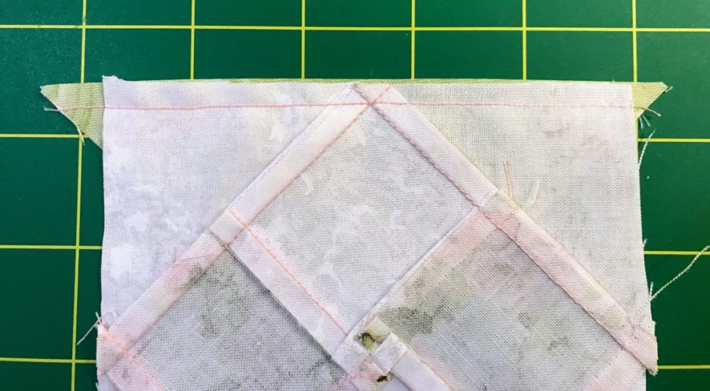 Sewing through the X to match the exact corner of a four patch block