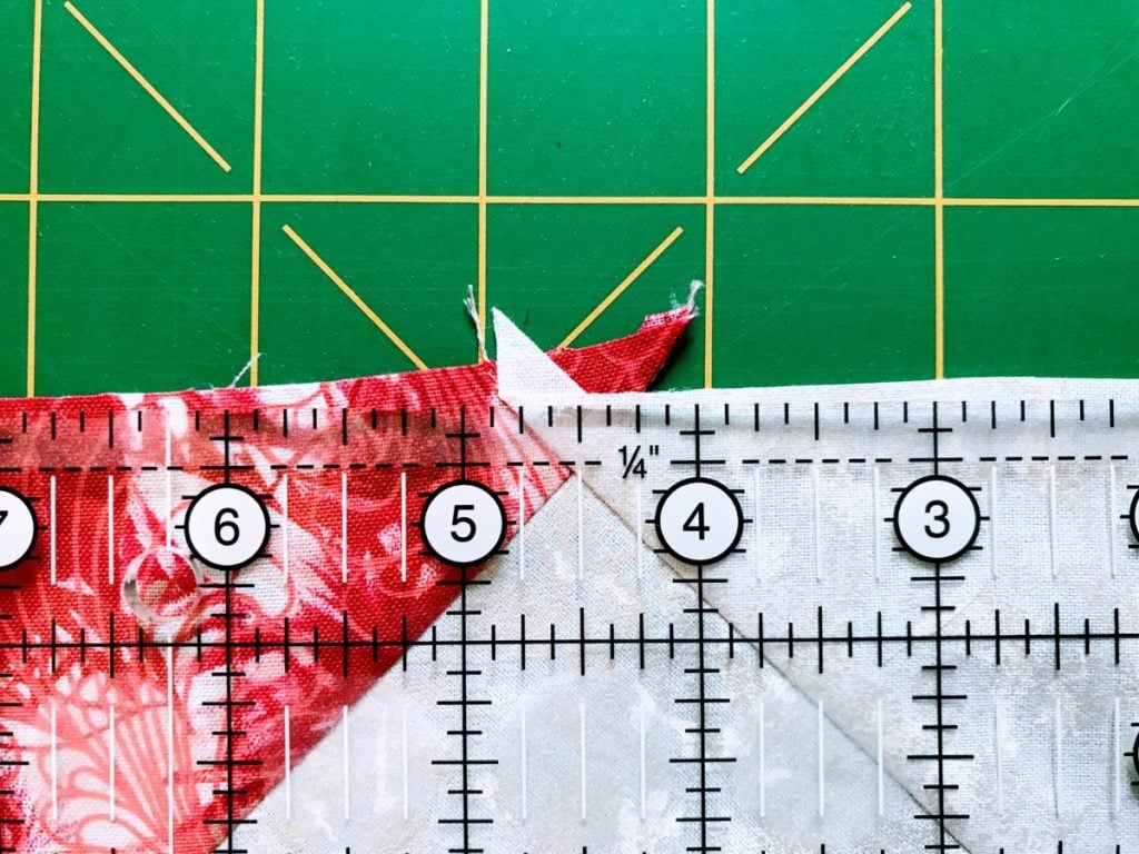 Leave a 1/4" seam above the point of a quilt block