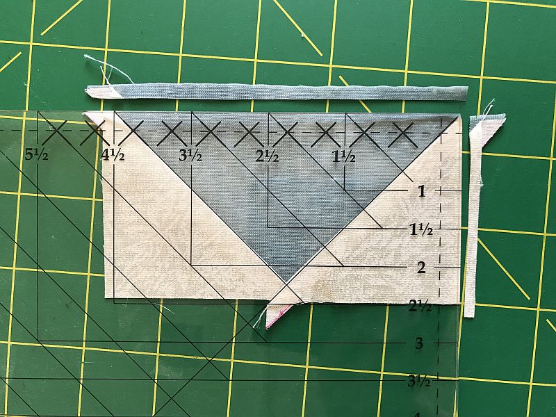 Picture showing the squaring-up step in making Flying Geese blocks using the Wing Clipper ruler.