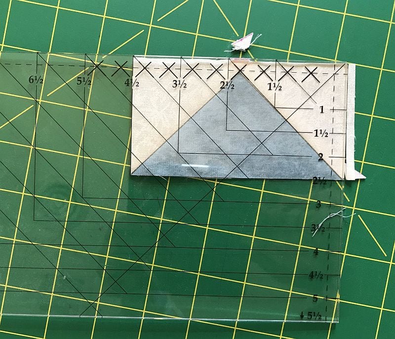 Picture showing the squaring-up step in making Flying Geese blocks using the Wing Clipper  ruler.