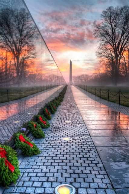 Vietnam Memorial Wall at Sunrise, showing a reflection of the Washington Monument
