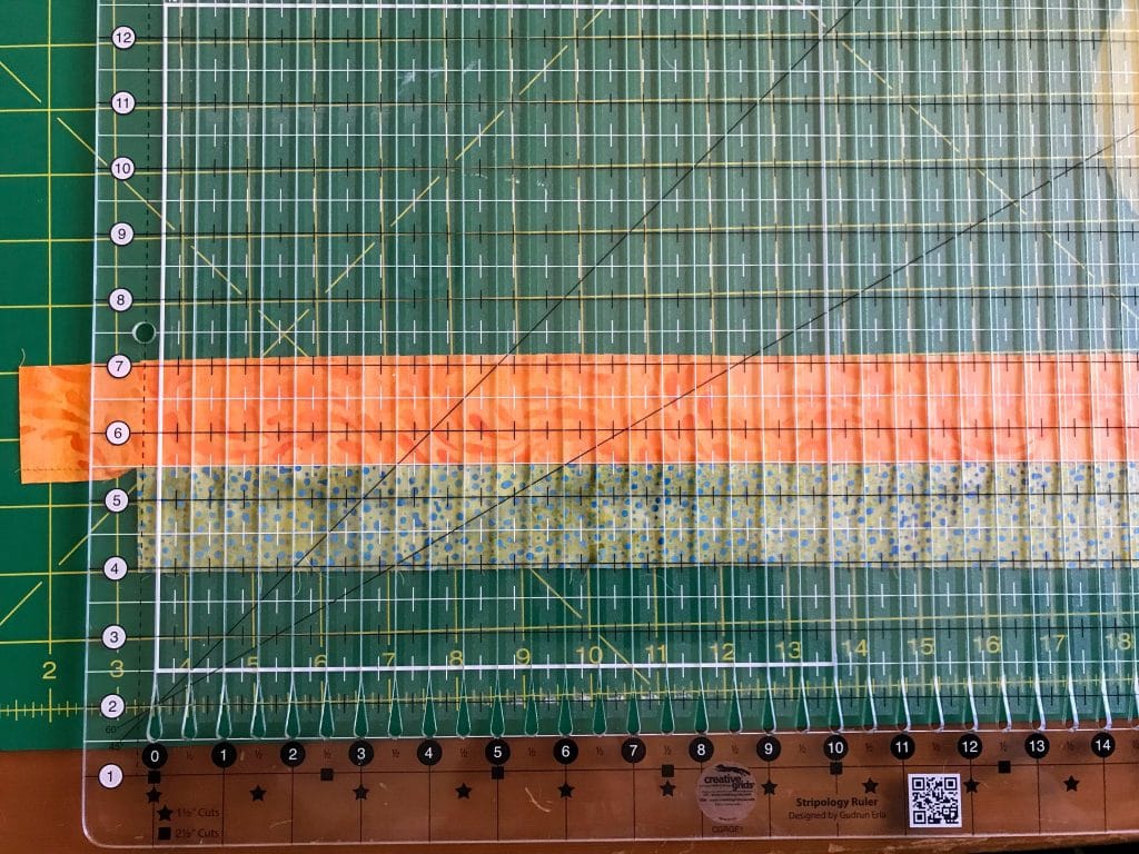 A Stripology Ruler being used to cut blocks