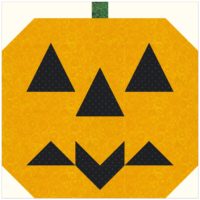Quilt Block showing a Pumpkin with a Bat Smile