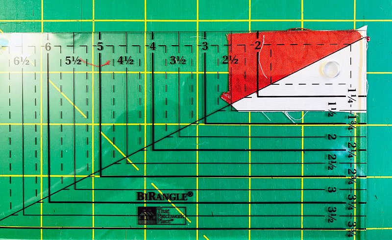Graphic showing how to use the Bi-Rangle Ruler to Square Up a Half-Rectangle Block