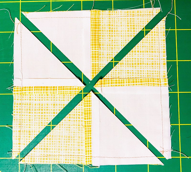 Transforming a four-patch quilt block into a quarter square triangle quilt block