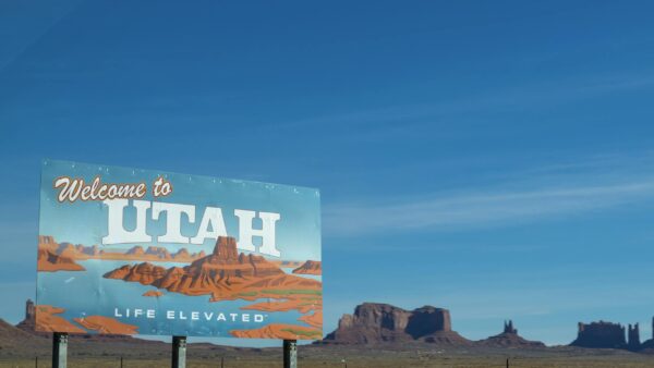 Scenic view of Utah welcome sign against desert and blue sky backdrop by Joshua T.