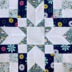 Colorful patchwork quilt with floral and geometric patterns showcasing quilting craftsmanship.