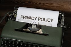 Privacy policy document on vintage typewriter for website privacy compliance.