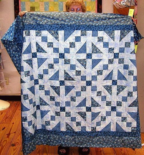 Colorful quilt showcasing intricate patchwork and quilting details for a cozy home décor project.