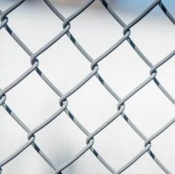 A chain-link fence with gray metal wire, symbolizing security and boundaries, ideal for illustrating secure data management or restricted access scenarios.