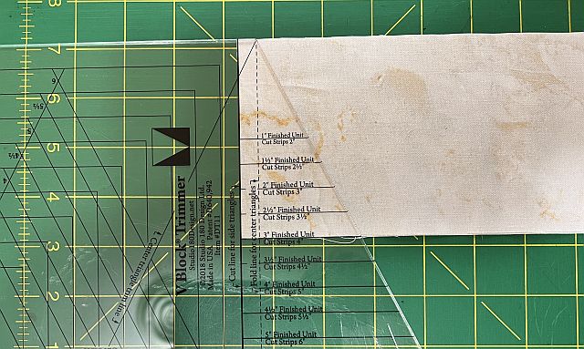 High-quality paper with printed rows of cut strip measurements on cutting mat, used for precise scrapbooking or craft projects using Scrapdash tools and techniques.