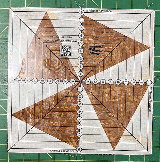 Scrapdash sewing pattern alignment ruler with brown fabric, perfect for quilting and sewing projects for accurate seam allowances.