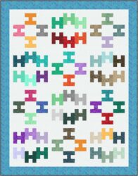 A quilt with a white background features twelve colorful geometric blocks in rows of three, each with a repeating pattern of interlocking rectangles in various colors, bordered by a blue patterned frame.
