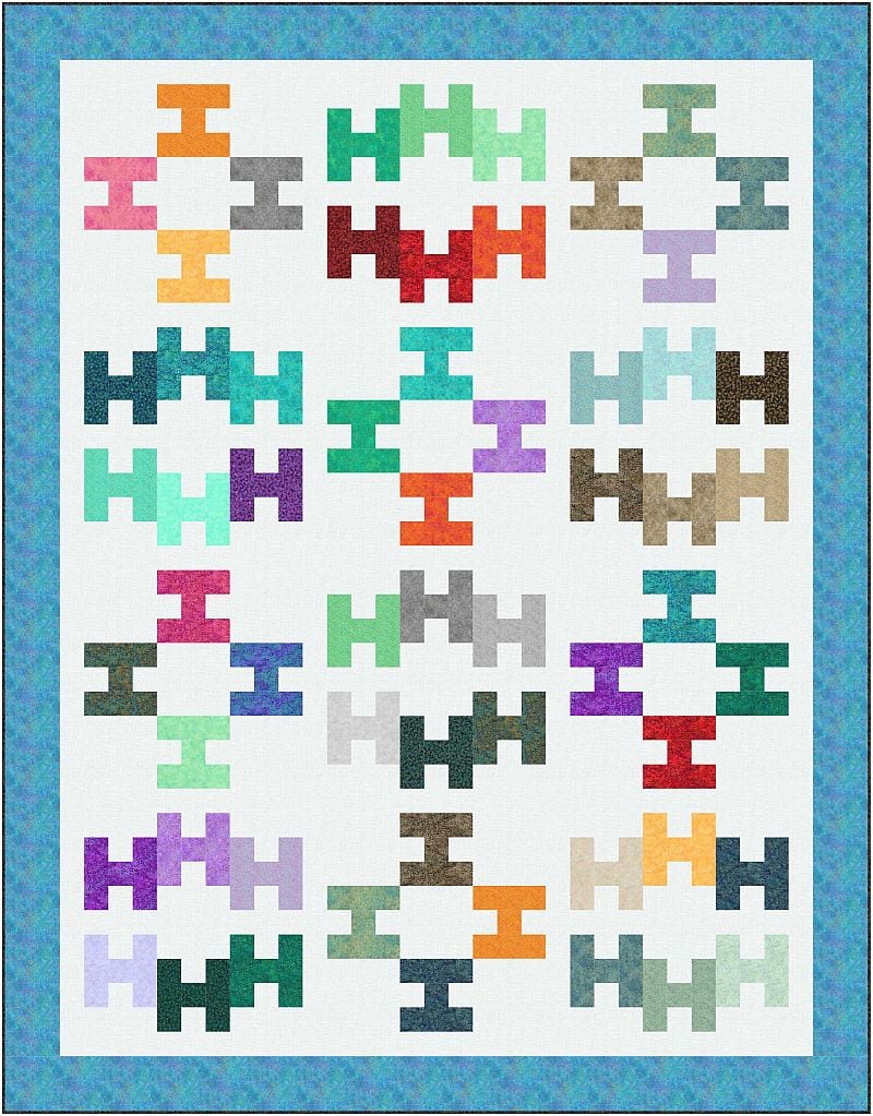A quilt with a white background features twelve colorful geometric blocks in rows of three, each with a repeating pattern of interlocking rectangles in various colors, bordered by a blue patterned frame.